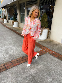 This paisley print top bring our your inner retro side. Top features a fun pink/orange coloring, oversized fit, long cuff sleeves, collar detail, functional button down closure and runs very oversized.