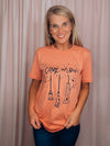 Graphic features a solid base colored tee, short sleeves, black design, unisex fit and runs true to size! -peach