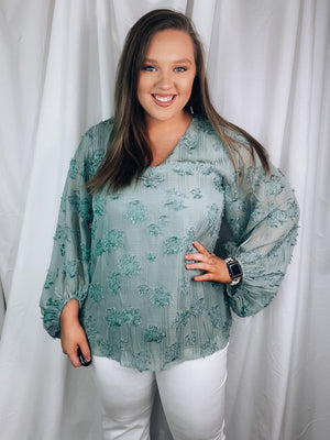 Top features a light sage base, 3/4 sleeve, lined underneath, V-neck line, elastic at the bottom of the sleeves, distressed detailing, relaxed fit and runs a little oversized.  *Aubree wore a MEDIUM and normally wears a LARGE.   *If you are big chested we recommend sticking with your normal size! 