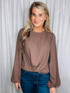 Top features a chocolate colored base, long sleeves, round neck line, cross twist detail and runs true to size! 