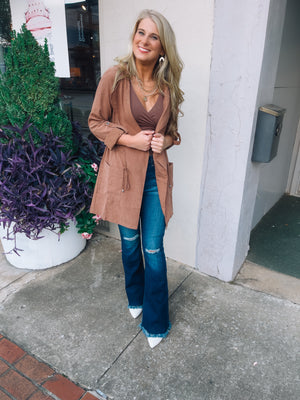 Jacket features a deep colored base, suede material, long sleeves, open front detailing, hood detail, elastic drawstring and runs true to size! -camel