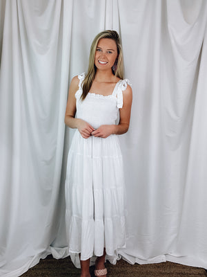 Dress offers adjustable tie straps, smocked chest detail, underlining, midi length and runs true to size. 