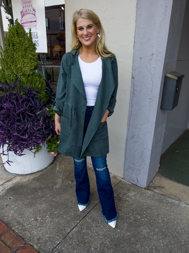 Jacket features a deep colored base, suede material, long sleeves, open front detailing, hood detail, elastic drawstring and runs true to size! -hunter green