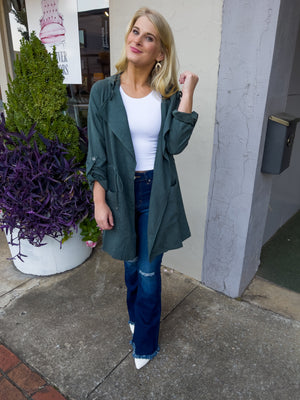 Jacket features a deep colored base, suede material, long sleeves, open front detailing, hood detail, elastic drawstring and runs true to size! -hunter green