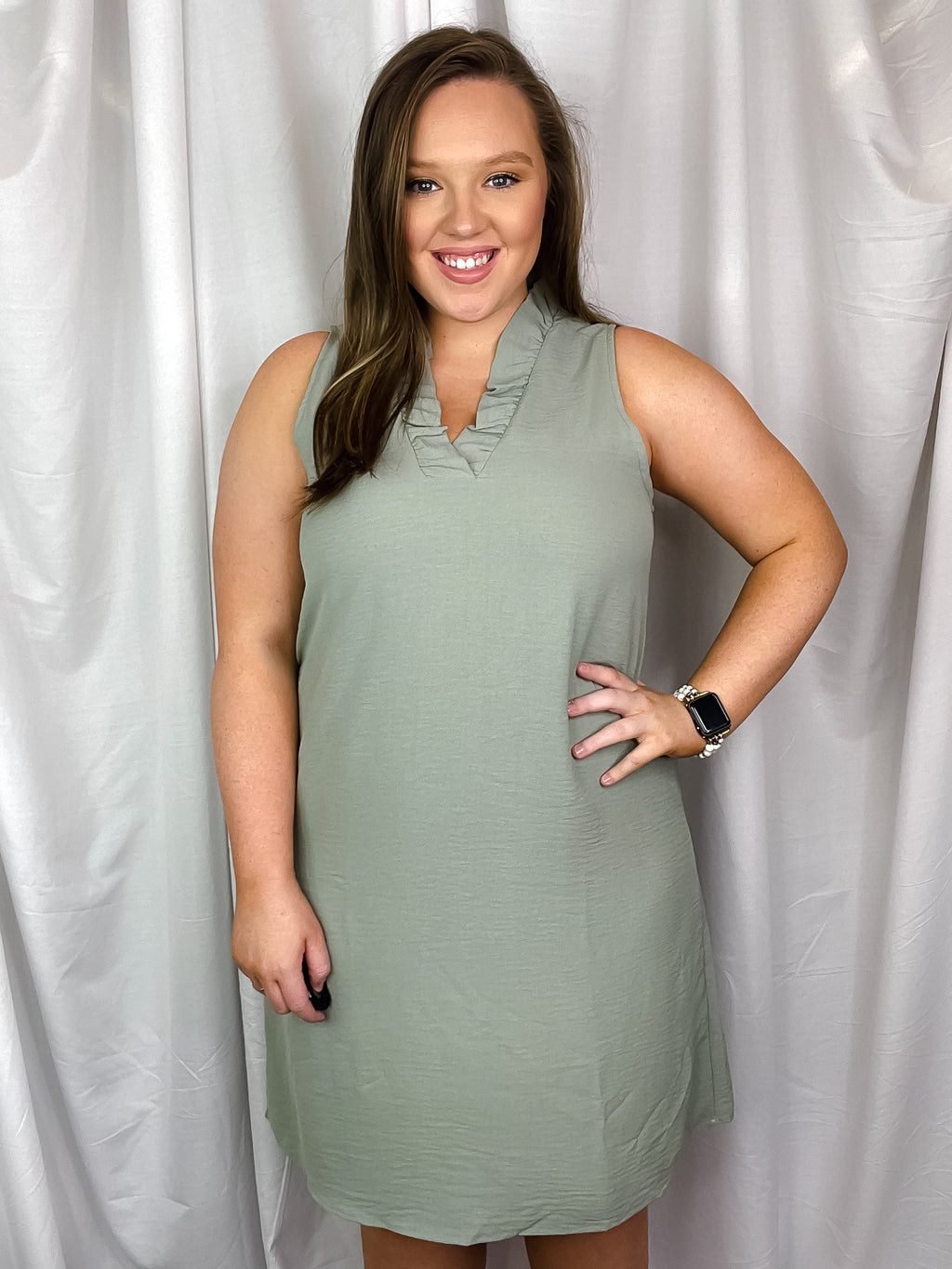 This dress features a sleeveless design with a perfect addition of ruffle V-neck detailing, leaving you feeling fun and professional all at the same time!-sage