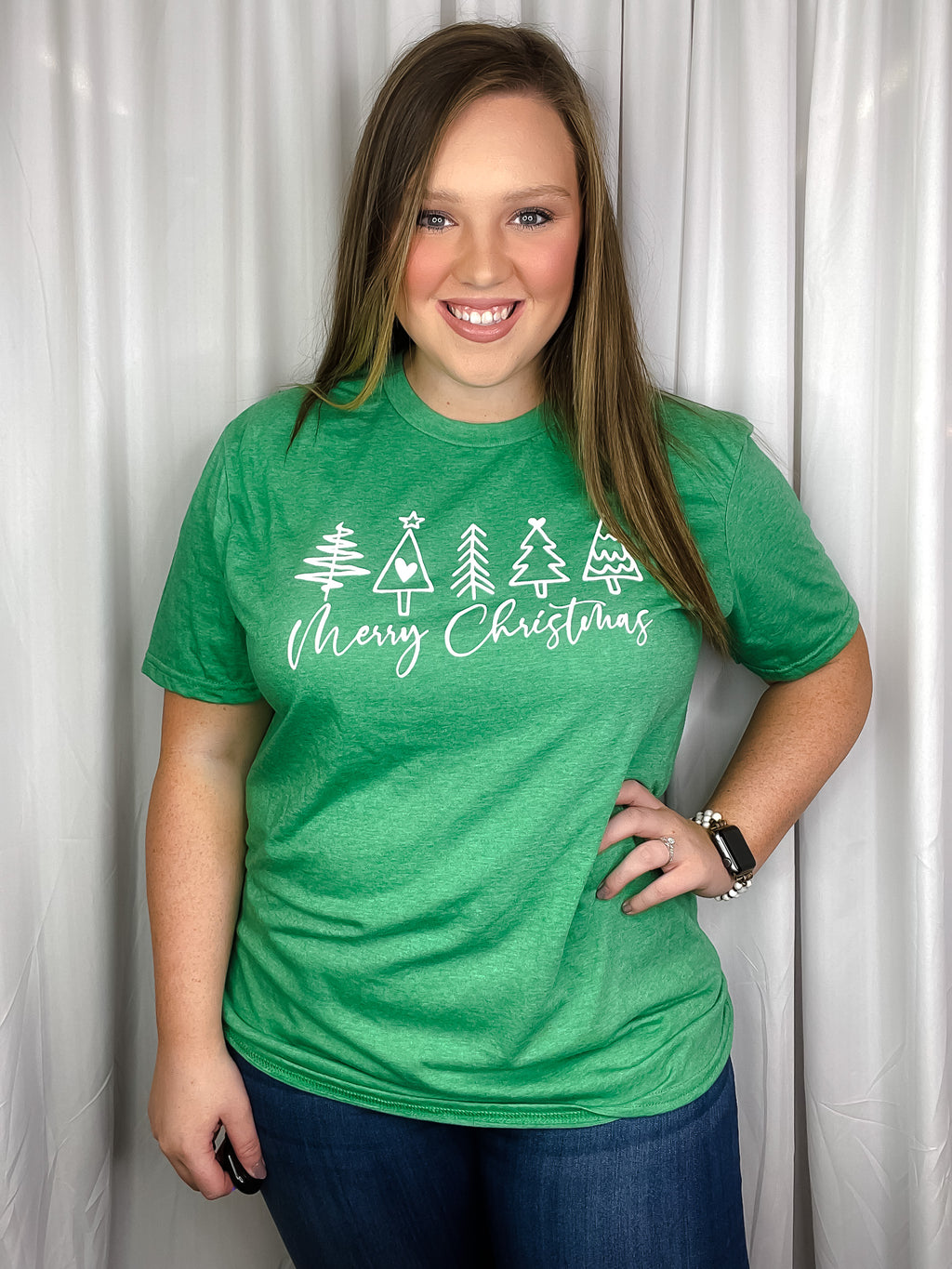 Graphic features a solid base color, short sleeves, white Merry Christmas with trees design, unisex fit and runs true to size!-green