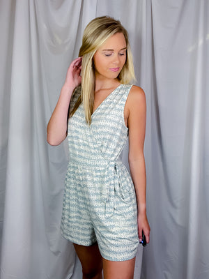 Romper features a cream-teal color, faux wrap detail to add nice detailing, functional pockets, V-neck line, sleeveless detail and runs true to size! 