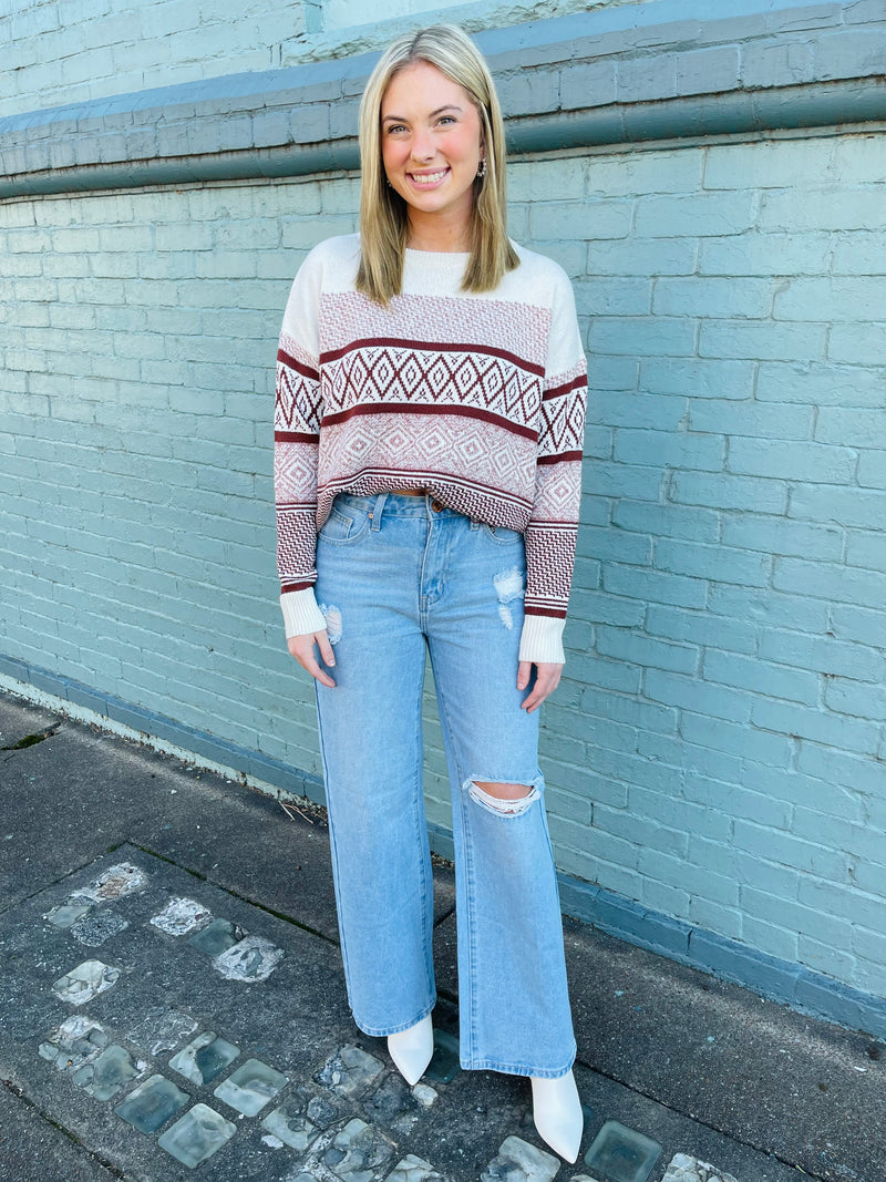 Sweater features an ivory base, rust colored geo pattern detail, crew neck line, long sleeves, cuddly fit and runs true to size! 