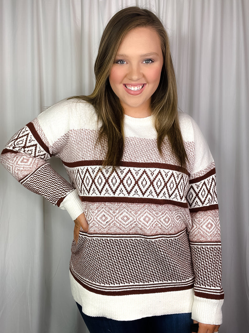 Sweater features an ivory base, rust colored geo pattern detail, crew neck line, long sleeves, cuddly fit and runs true to size! 