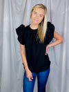 Top features a solid color allowing easy pairing, short ruffle sleeves to add detailing, round neck line, comfortable everyday fit and runs true to size! -black