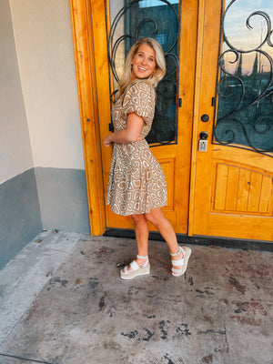 This mini dress is perfect for a sunny outing. Its tan hue, short sleeves, and side cutouts elegantly balance the abstract print, making it an ideal choice for those looking to look stylish and stay cool. Vacay ready, this piece is sure to be a crowd pleaser.