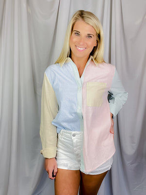 Top features a solid base color, multi color striped detail, light weight material, long sleeves, front pocket, button down detail, and runs true to size!   Materials:  100% Cotton