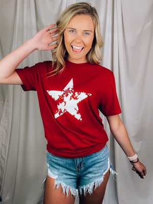 Graphic features a solid base color, distressed star print, short sleeves, round neck line, unisex fit and runs true to size! 