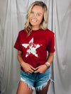 Graphic features a solid base color, distressed star print, short sleeves, round neck line, unisex fit and runs true to size! 