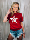 Graphic features a solid base color, distressed star print, short sleeves, round neck line, unisex fit and runs true to size! 