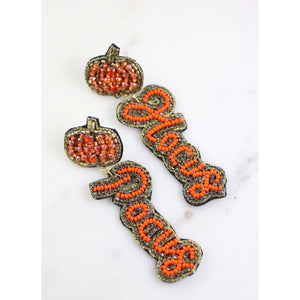 It's just a bunch of Hocus Pocus! This Halloween themed earring has beading and rhinestones with a pumpkin post.  Dimensions: 3.5" long by 1" wide-orange