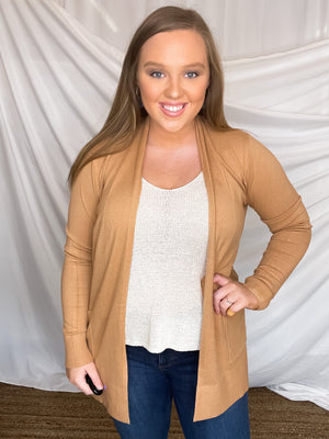 Cardigan features a solid base color, long sleeve, thin material, light weight material, 2 front pockets and runs true to size!- CAMEL