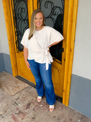 Top features a solid base color, slight textured material, 3/4 kimono sleeves, round neck line, flattering side tie detail and runs true to size! -oatmeal