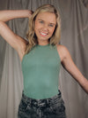 Bodysuit features a solid base color, thick comfy material, round neck line, sleeveless detail, fitted fit, and runs true to size!-green