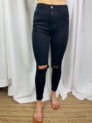Jeans feature a jet black color, front distressing, skinny leg fit, high waist line and runs true to size! 