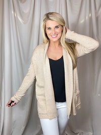 Cardigan features an oatmeal base, heathered detail, open front, long sleeveless light weight material and runs true to size! 