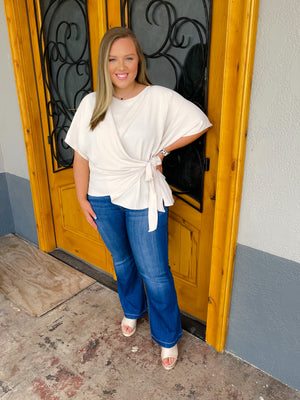 Top features a solid base color, slight textured material, 3/4 kimono sleeves, round neck line, flattering side tie detail and runs true to size! -oatmeal