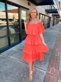 Dress features a coral color, layered detailing, off/on shoulder detail, underlining, midi length and runs true to size! 