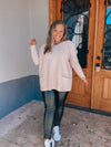 Top features a solid base color, long sleeves, front pocket detail, round neck line, cozy material and runs true to size! -taupe