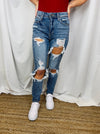Jeans feature a medium denim wash, front distressing, high waist detail, mom jean fit, functional pockets and runs true to size! 