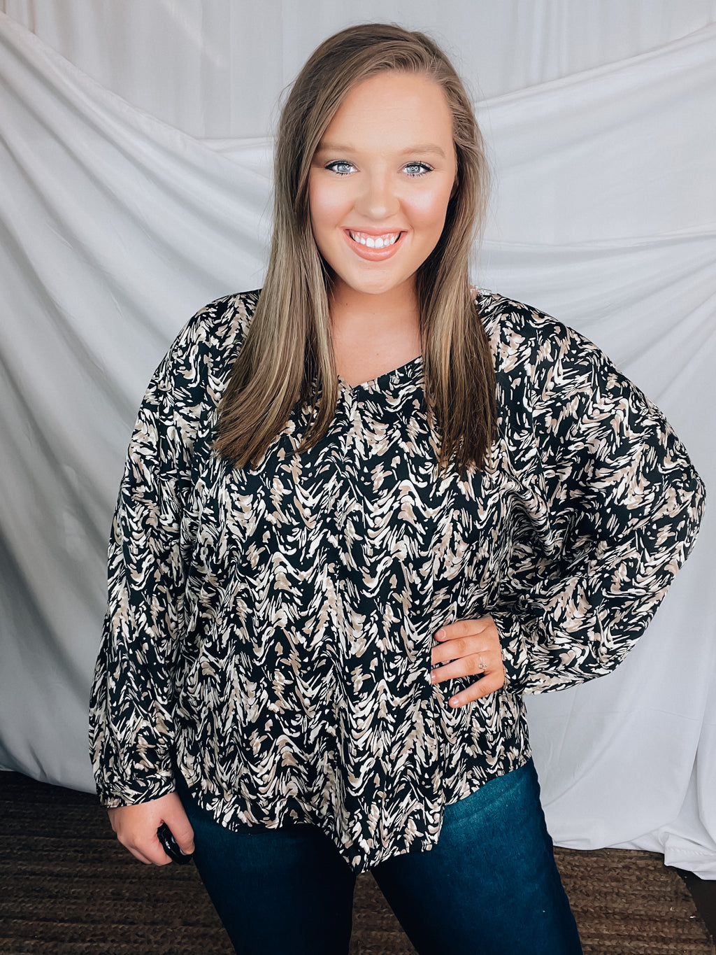 Top features a black base, taupe and cream abstract print, long sleeves, V-neck line, comfy fit and runs true to size! 