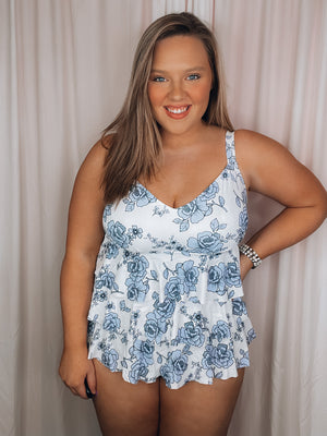 Beach babes, get ready! Our 'Along The Shore' One Piece will have you looking and feeling like a million bucks. Featuring adjustable straps and full coverage, you can rock this piece with confidence. Plus, its flirty layered skirt detail and light sky rose pattern design will have you turning heads, wherever you go. Spring into summer with this must-have swimsuit!