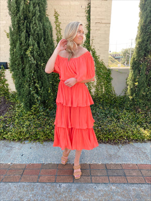 Dress features a coral color, layered detailing, off/on shoulder detail, underlining, midi length and runs true to size! 