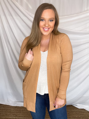 Cardigan features a solid base color, long sleeve, thin material, light weight material, 2 front pockets and runs true to size!- CAMEL