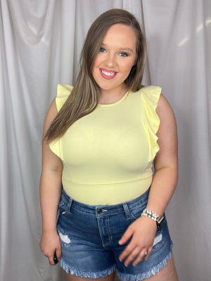Bodysuit features a suede material, short sleeves, snap bottom detail, ruffle side detailing, round neck line, fitted fit and runs true to size!-yellow