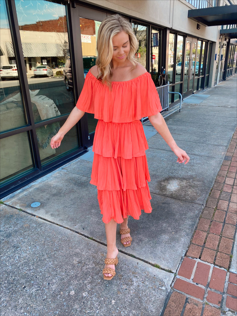 Dress features a coral color, layered detailing, off/on shoulder detail, underlining, midi length and runs true to size! 