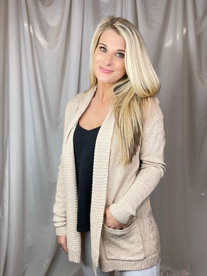 Cardigan features an oatmeal base, heathered detail, open front, long sleeveless light weight material and runs true to size! 