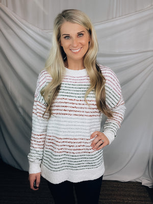 Sweater features an ivory base, thin multi colored stripes, round neck line, long sleeves, soft material and runs true to size!-OLIVE