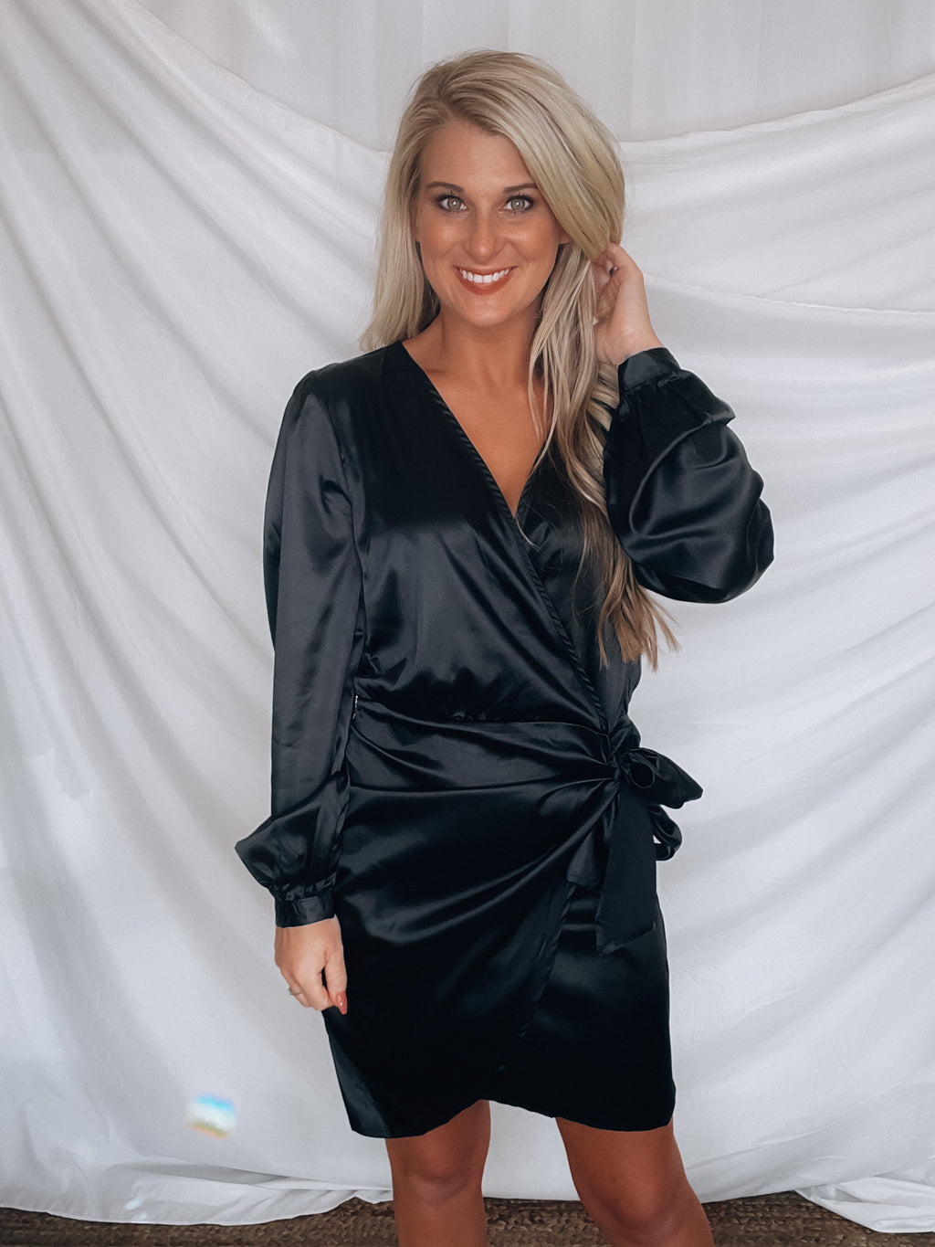 Dress features a silk material, robe wrap detail, mini length, tulip skirt, button closure back, long sleeves, functional waist tie and runs true to size!-BLACK