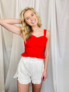 Bottoms feature a solid base color, elastic waistband, ruffle detailing around the pockets and bottom of the shorts, functional pockets, under lining and runs true to size!-white