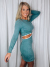 Dress features a teal base, cream outlining detail, cut out side detailing, soft ribbed material, long sleeves, round neck line and runs true to size! 
