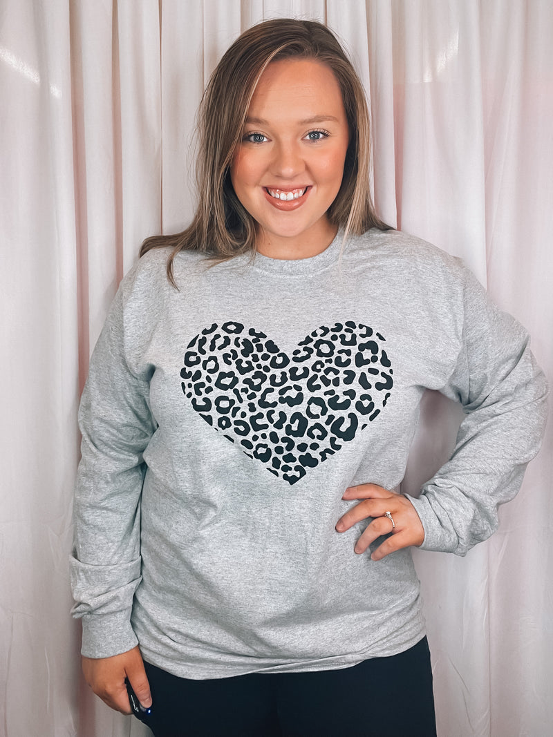 Graphic features a grey colored tee, black leopard heart design, long sleeves, round neck line, unisex fit and runs true to size! 