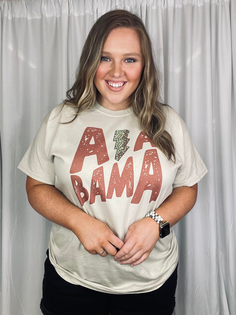 Graphic tee features a sand base tee, leopard lighting bolt detail, blocked print, short sleeves, unisex fit and runs true to size! 