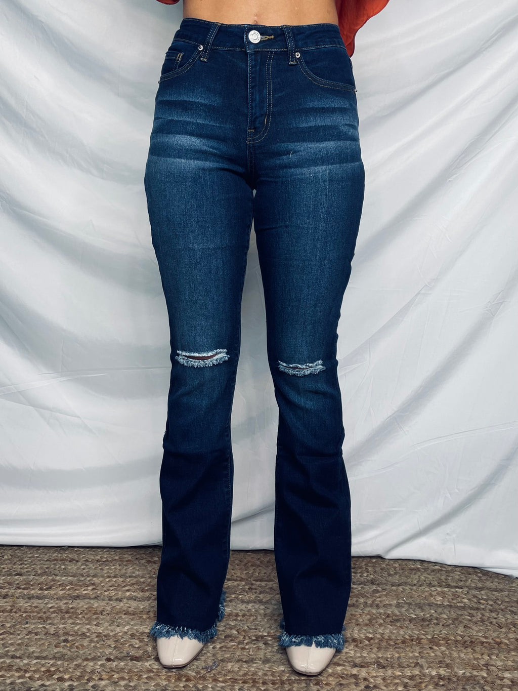 Jeans feature a dark wash, knee distressing, flared leg, frayed bottom, functional pockets, 32" inseam, high waisted and runs true to size!   Measurement (Based on size 5) - Inseam: 32" - Rise (To top edge of band): 10" - Leg Opening: 21"  Composition For Color S933: - 73% Cotton/ 25% Polyester/ 2% Spandex