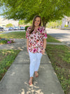 Top features an ivory base, multi colored floral print, short sleeves, V-neck line and runs true to size! 