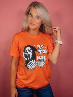Graphic features a solid base color, black & white scream design, short sleeves, unisex fit and runs true to size! -orange