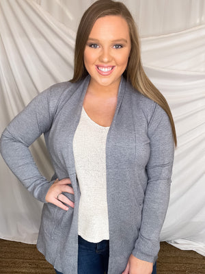 Cardigan features a solid base color, long sleeve, thin material, light weight material, 2 front pockets and runs true to size!-  CHARCOAL