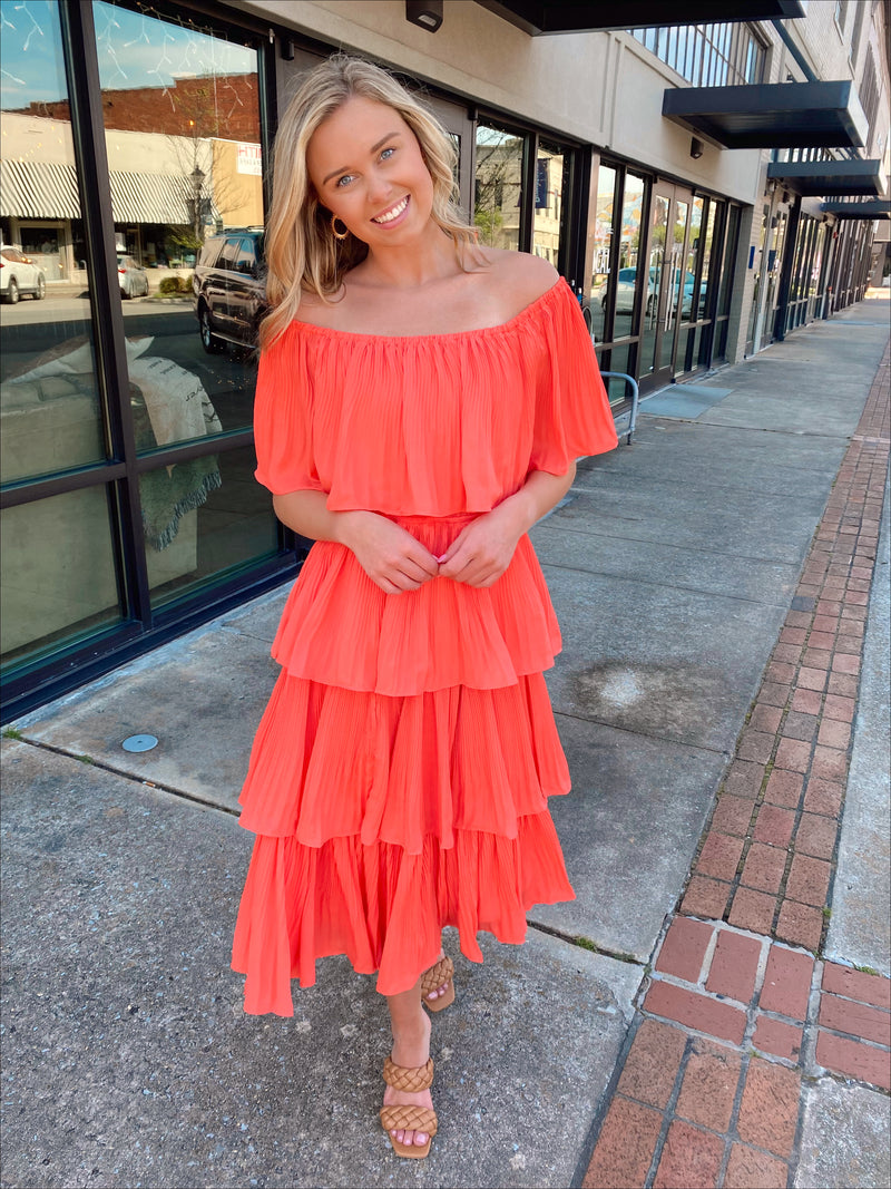 Dress features a coral color, layered detailing, off/on shoulder detail, underlining, midi length and runs true to size! 