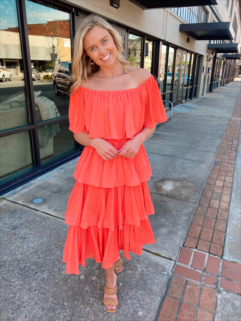 Dress features a coral color, layered detailing, off/on shoulder detail, underlining, midi length and runs true to size! 
