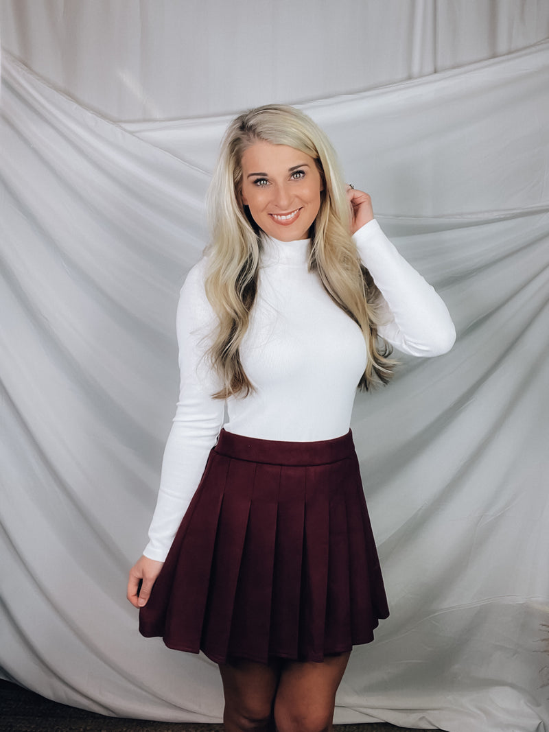 Skirt features a suede material, burgundy color, pleated detail, fitted waist, thicker material and runs true to size! 