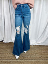 Jeans feature a flare bottom, medium wash, frayed bottoms, functional pockets, zipper closure, belt loops, distressed bottoms, and runs true to size! 